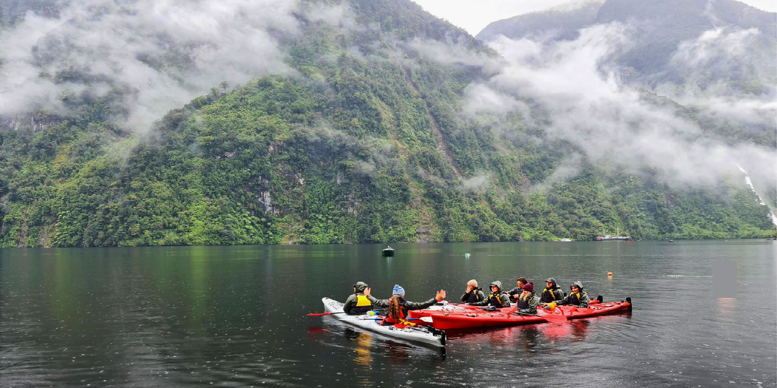A double kayak being paddled in Doubtful Sound